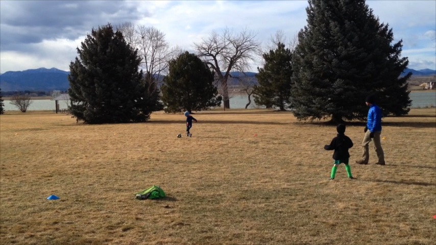 Soccer Practice: Ted scores a goal in practice on a very windy day.