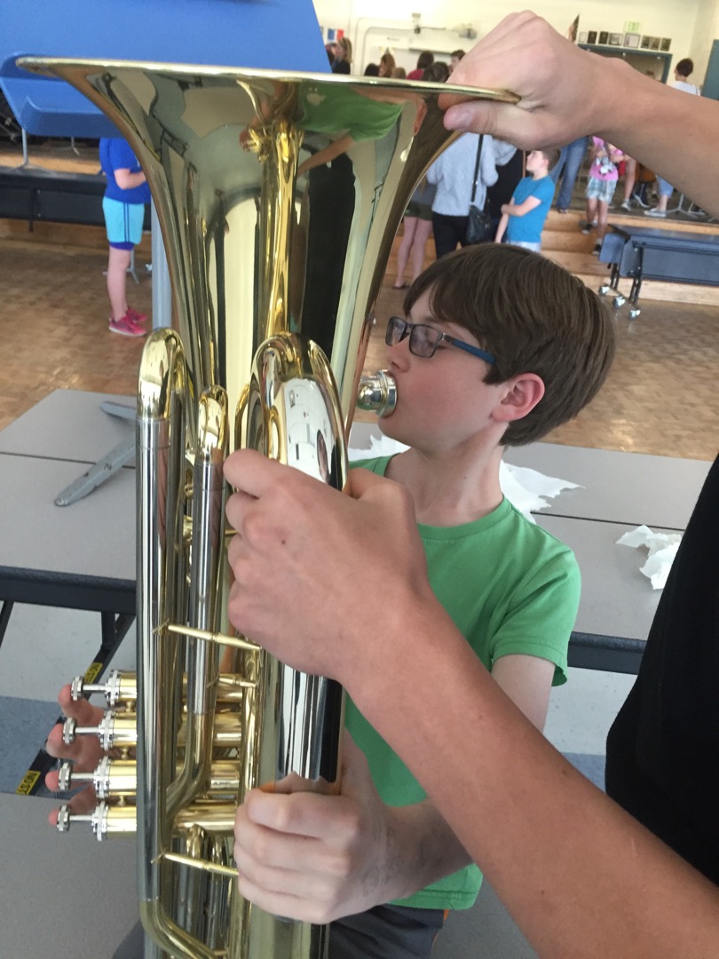 Trying the tuba at middle school instument demo night