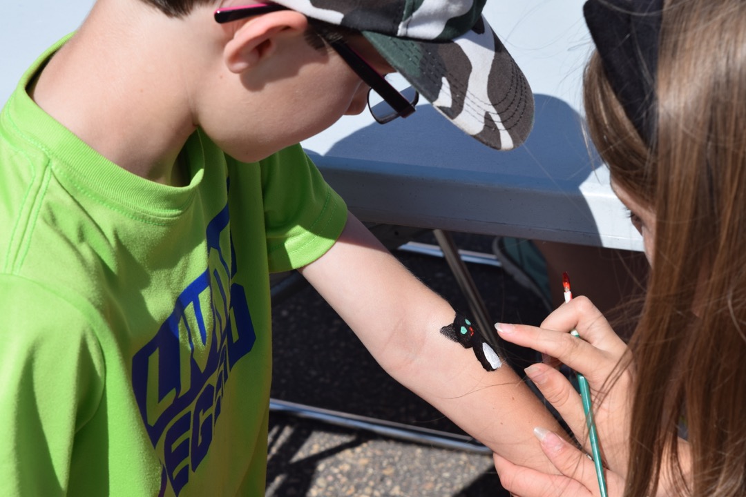 Ted gets Henry painted on his arm during field day