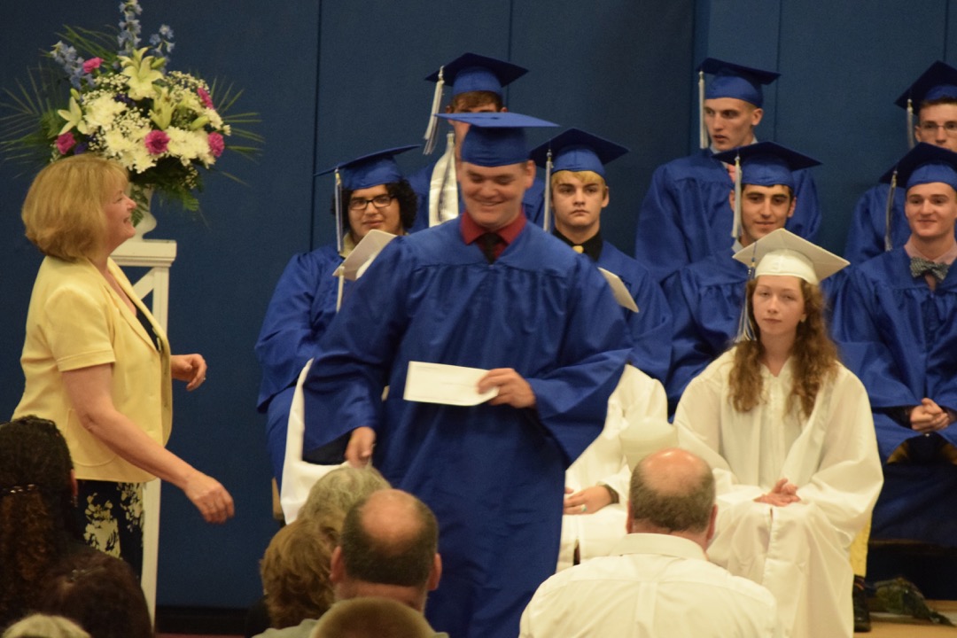 Sam happily accepting one of his scholarships