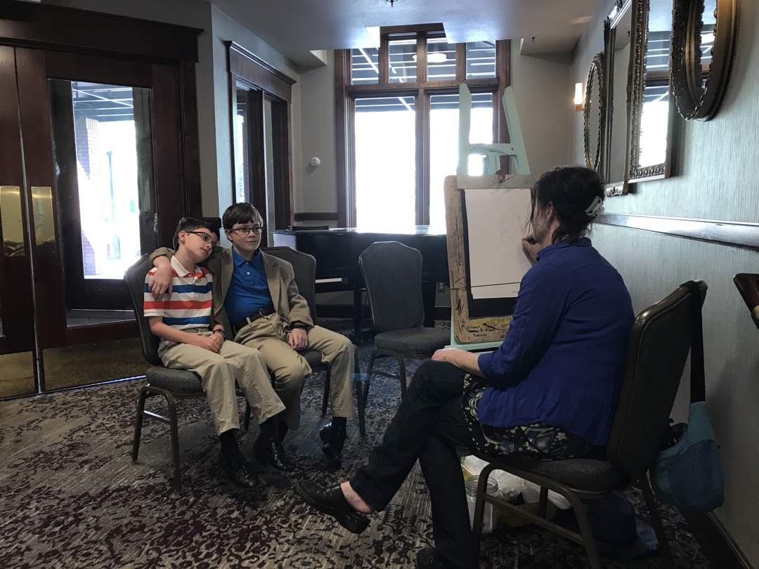 Sitting for a caricature at Mother's Day brunch