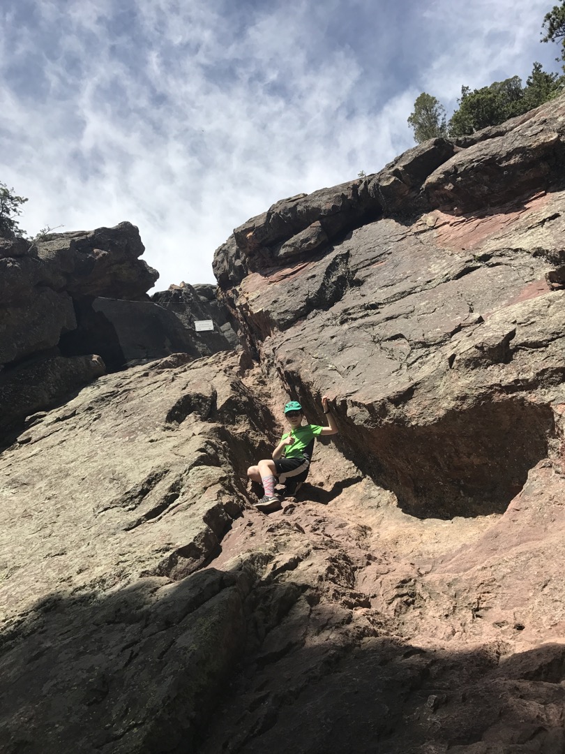 Tim scrambles part way up the cave entrance