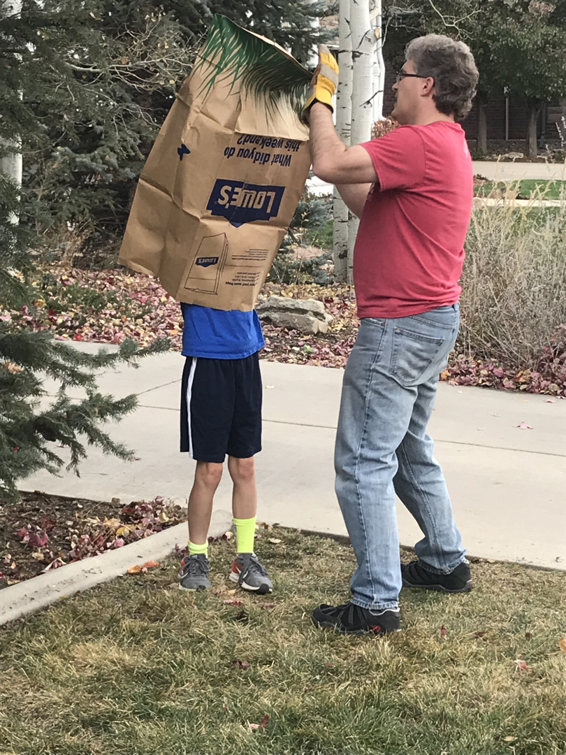 Ted helps open a new leaf bag