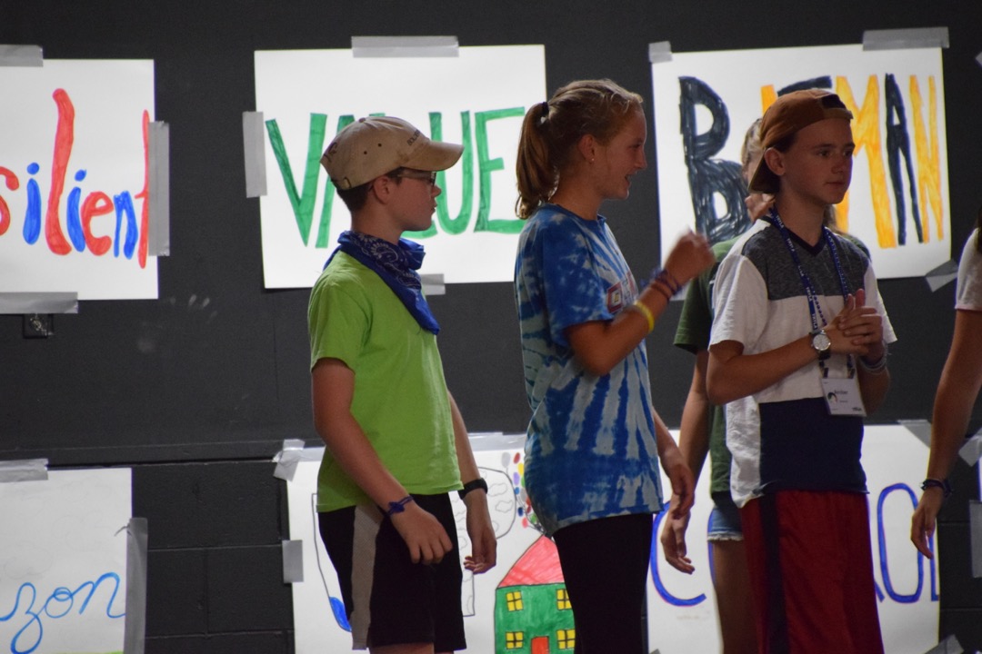 Team F goes on stage to talk about their camp experience
