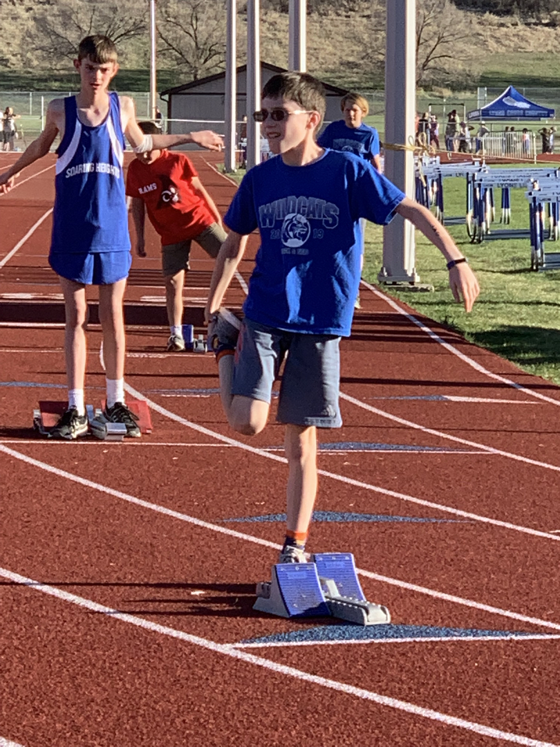 Stretching before the 400M at the district 6th grade track meet