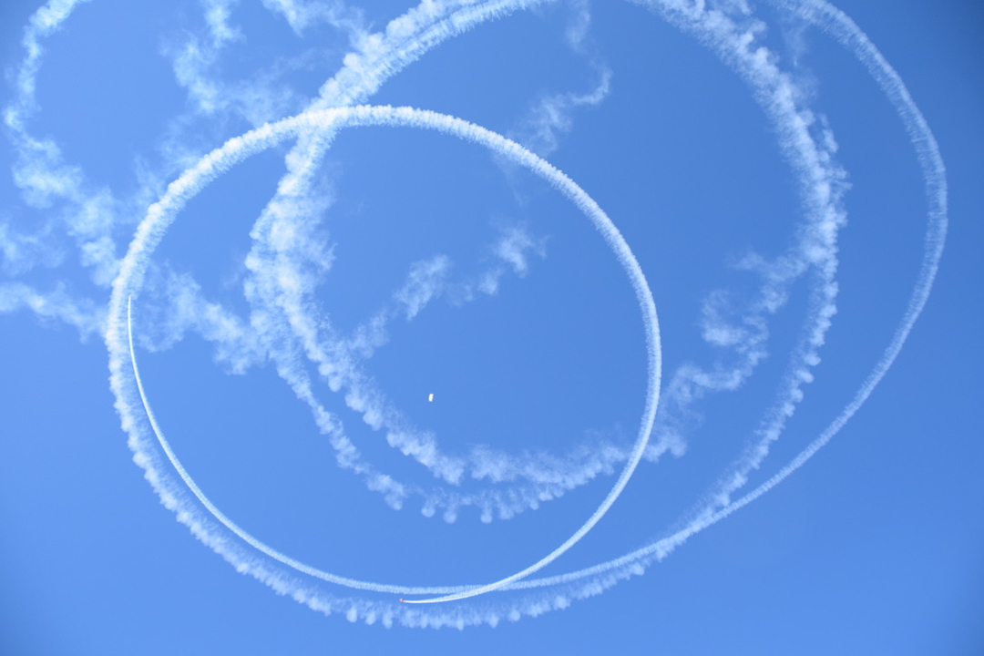 The little planes loop circles around the last parachute