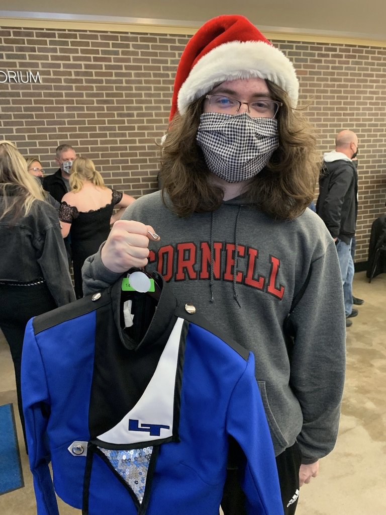 Tim helps out with the marching band uniform