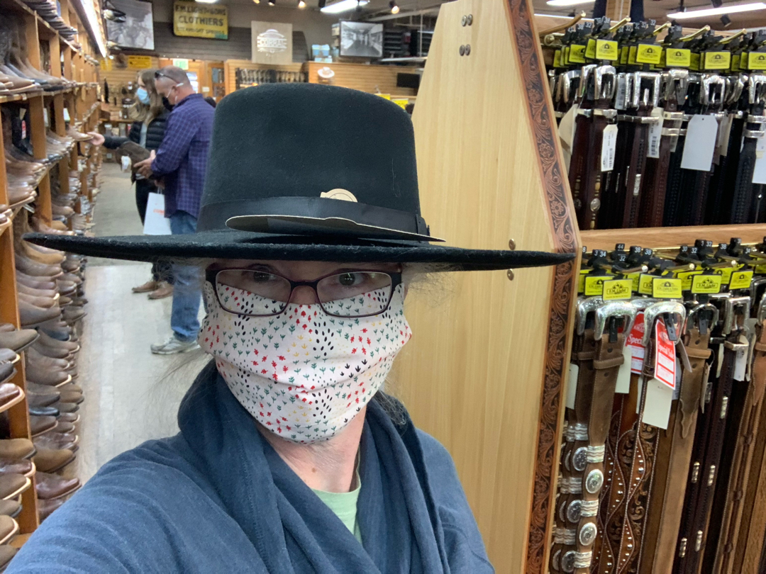 Trying on hats in F.M. Light & Sons