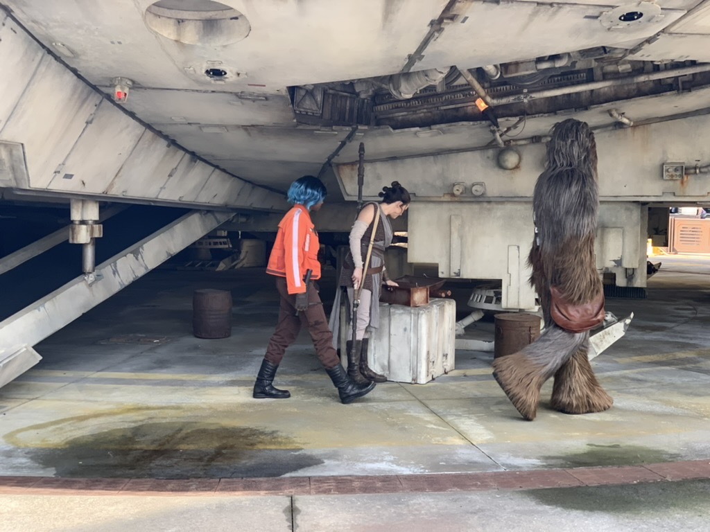 Vi, Rey and Chewie work on the Millennium Falcon
