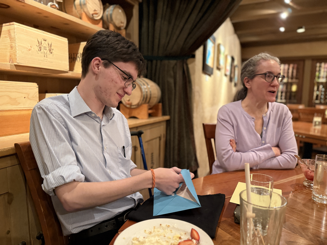 Enjoying some gifts at his celebratory dinner
