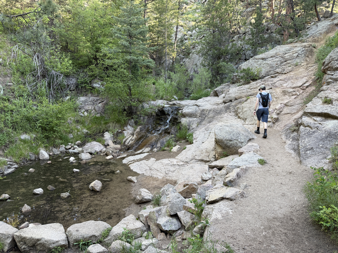 Ted hikes near a waterfall